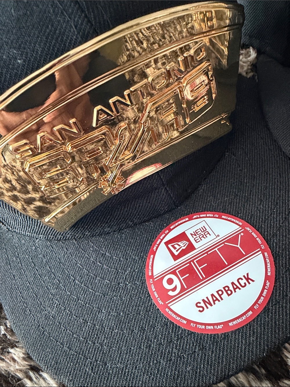 New Era Black Snapback Cap with Gold Metallic Front Plate